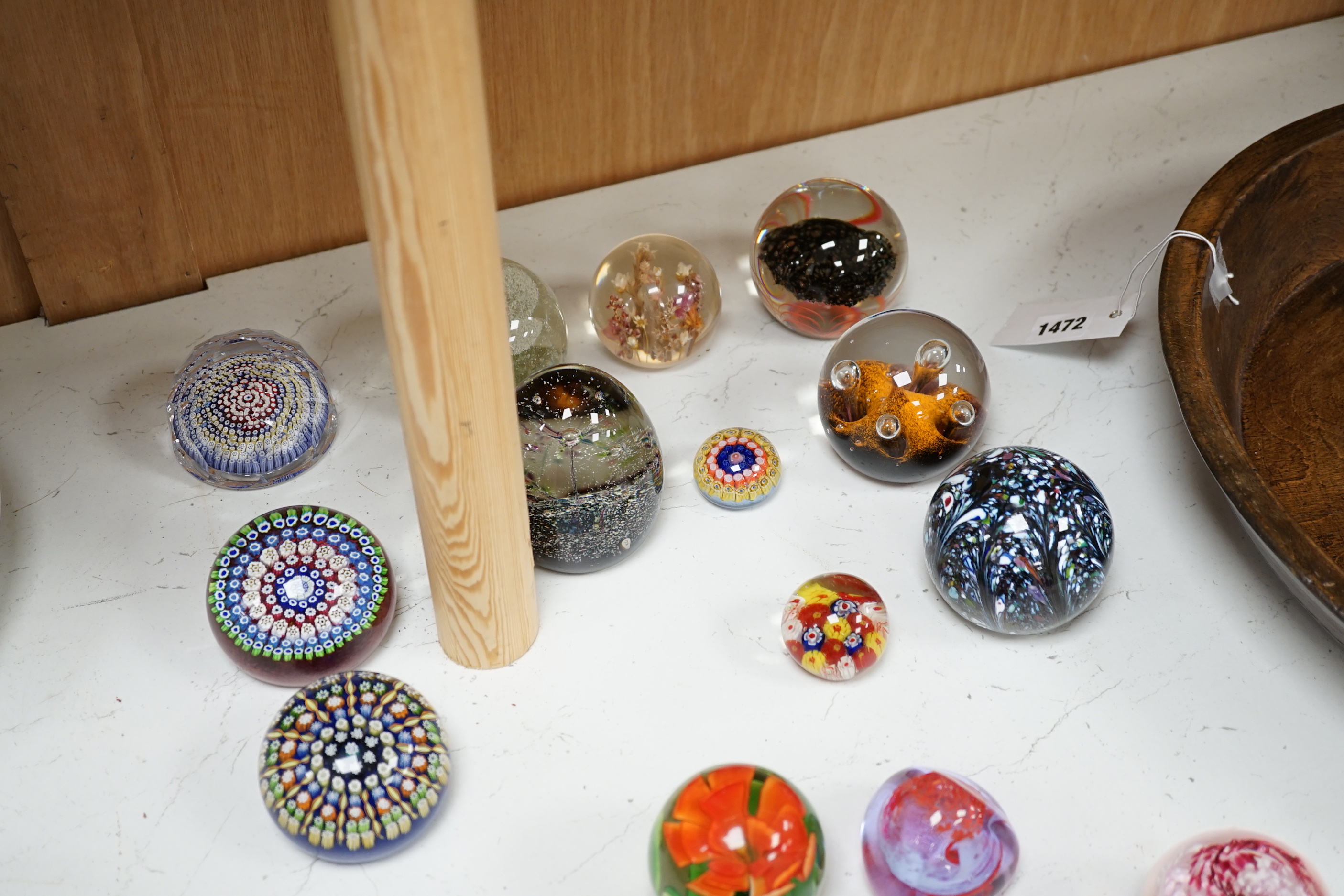 A collection of nineteen glass paperweights; mostly Caithness with two being Whitefriars and another Perthshire